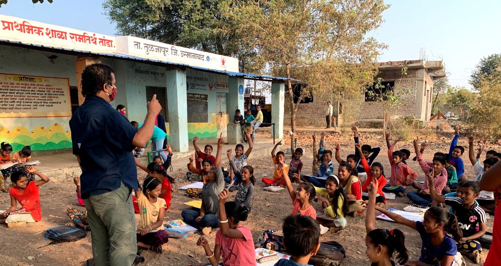 Outdoor classroom with students and a teacher